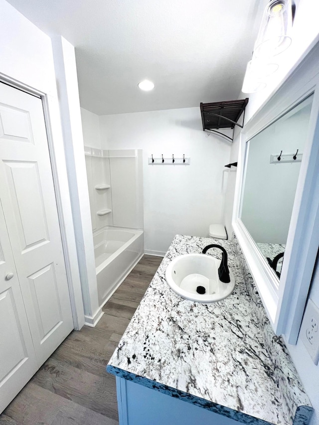 bathroom featuring bathing tub / shower combination, vanity, and hardwood / wood-style flooring