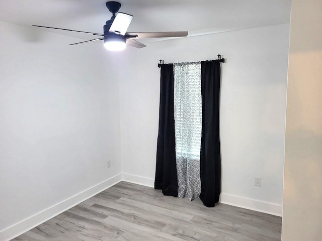 empty room with light wood-type flooring and ceiling fan