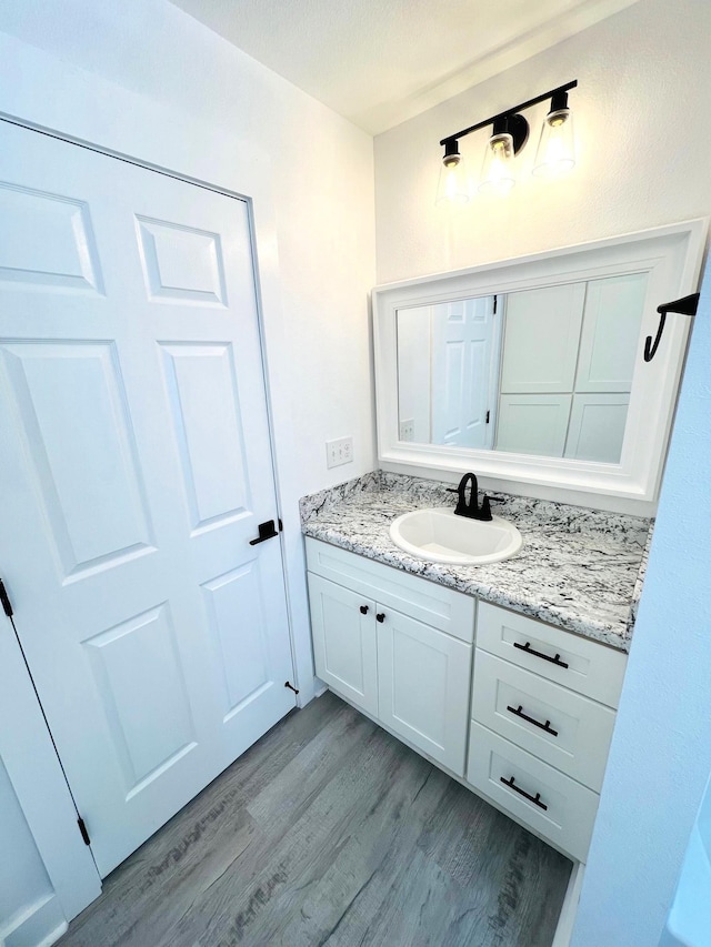 bathroom featuring hardwood / wood-style flooring and vanity