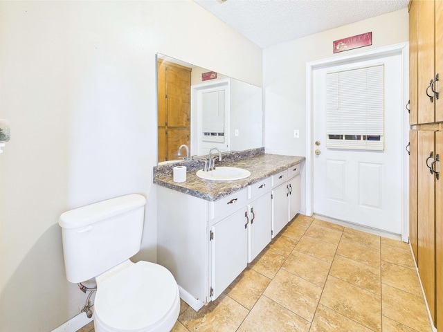 3696 Joel Aman Rd, Perry, FL 32347 - bathroom with toilet, a textured ceiling, vanity, and tile patterned flooring
