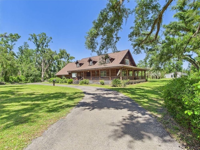 3696 Joel Aman Rd, Perry, FL 32347 - view of front of home with a porch, a front lawn, and driveway