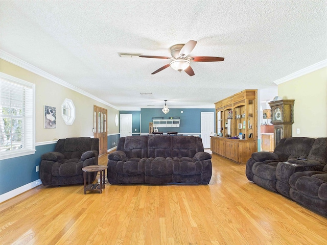 3696 Joel Aman Rd, Perry, FL 32347 - living room with a textured ceiling, light wood-style flooring, crown molding, ceiling fan, and baseboards