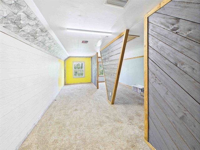 3696 Joel Aman Rd, Perry, FL 32347 - corridor with wooden walls, vaulted ceiling, and carpet flooring