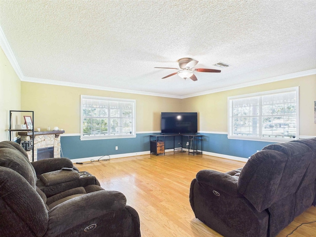 3696 Joel Aman Rd, Perry, FL 32347 - living area with wood finished floors, ceiling fan, healthy amount of natural light, ornamental molding, and a textured ceiling