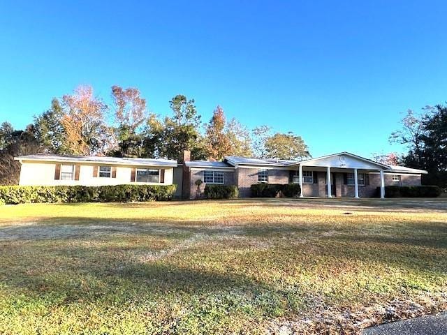 ranch-style home featuring a front yard