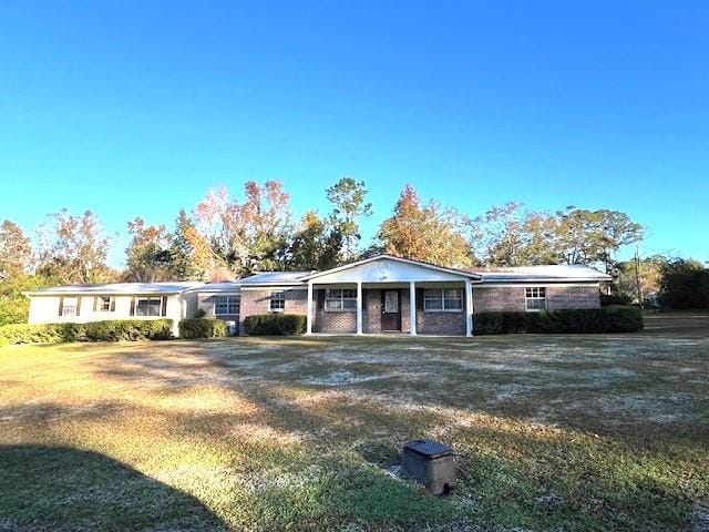 single story home with a front yard and a porch