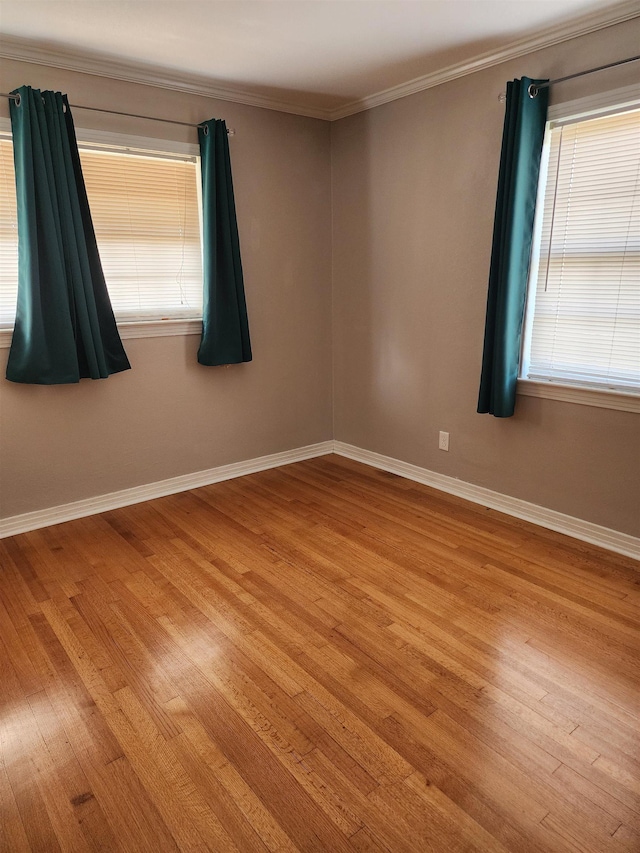 unfurnished room featuring crown molding and light hardwood / wood-style flooring