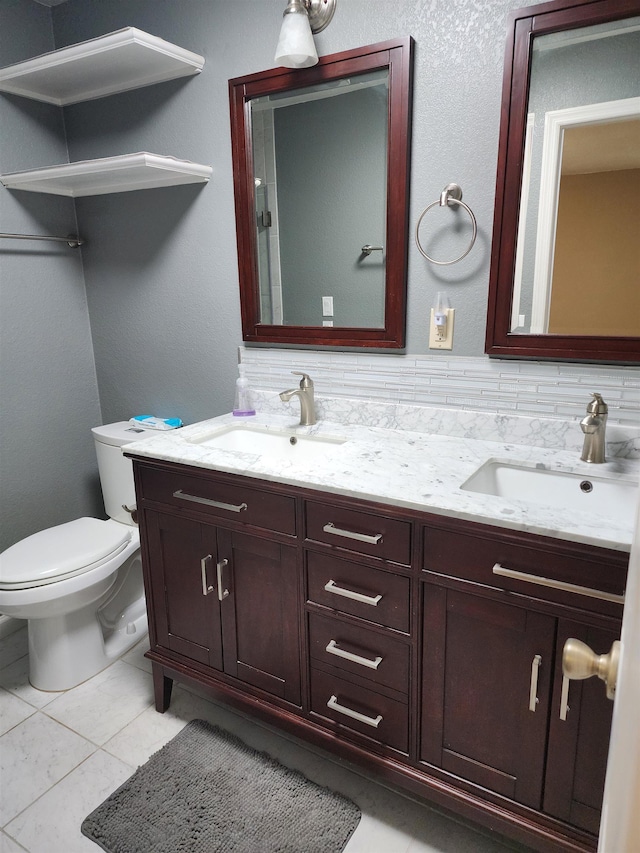 bathroom featuring tile patterned floors, vanity, and toilet