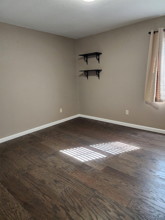 empty room featuring dark wood-type flooring