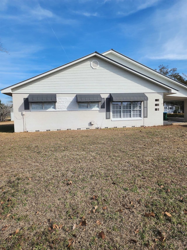 view of side of home featuring a yard