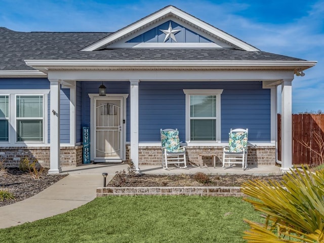 property entrance featuring a yard and covered porch