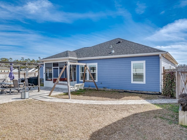 back of house with a sunroom and a patio area