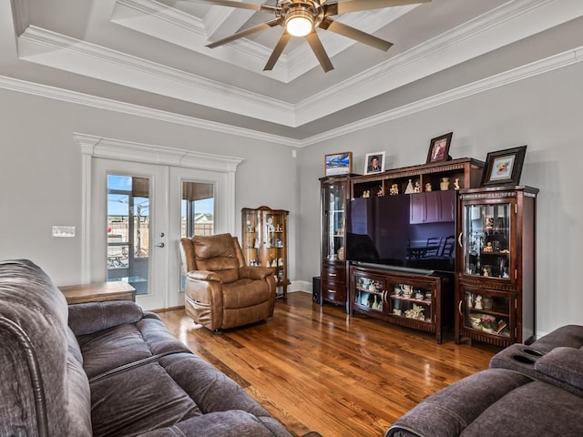 living room featuring french doors, crown molding, a raised ceiling, ceiling fan, and hardwood / wood-style floors