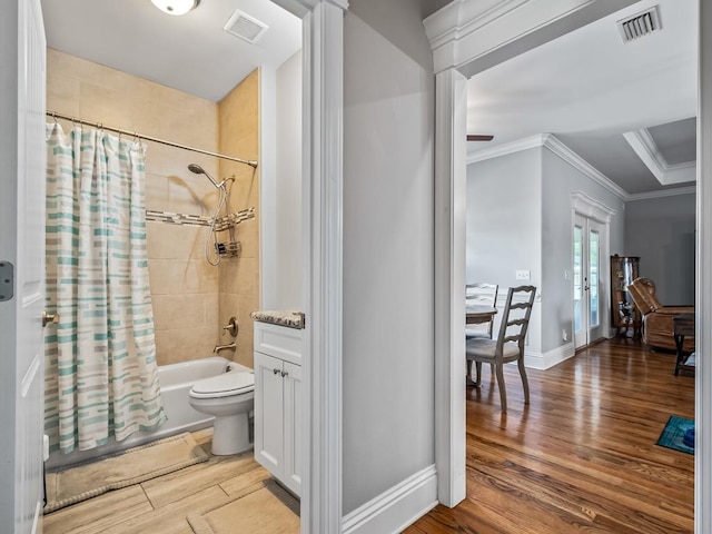 full bathroom featuring toilet, crown molding, shower / tub combo, vanity, and hardwood / wood-style floors