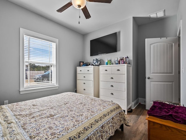 bedroom with ceiling fan and dark hardwood / wood-style flooring