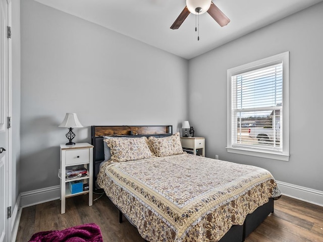 bedroom with ceiling fan and dark hardwood / wood-style flooring