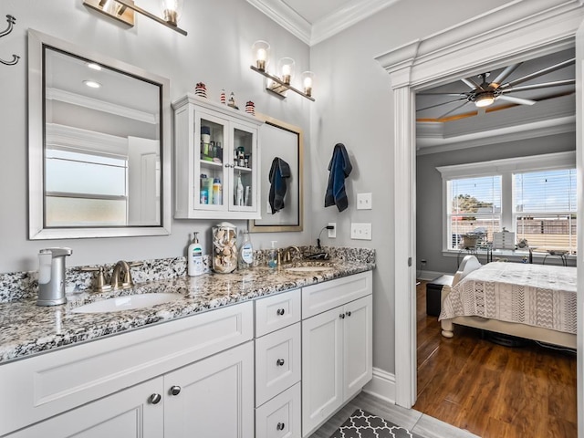 bathroom with vanity, crown molding, ceiling fan, and hardwood / wood-style flooring