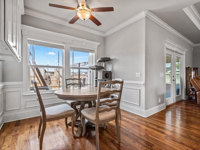 dining room featuring crown molding, dark hardwood / wood-style floors, and a wealth of natural light