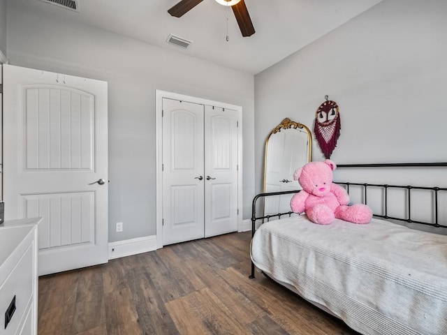 bedroom with a closet, dark hardwood / wood-style floors, and ceiling fan