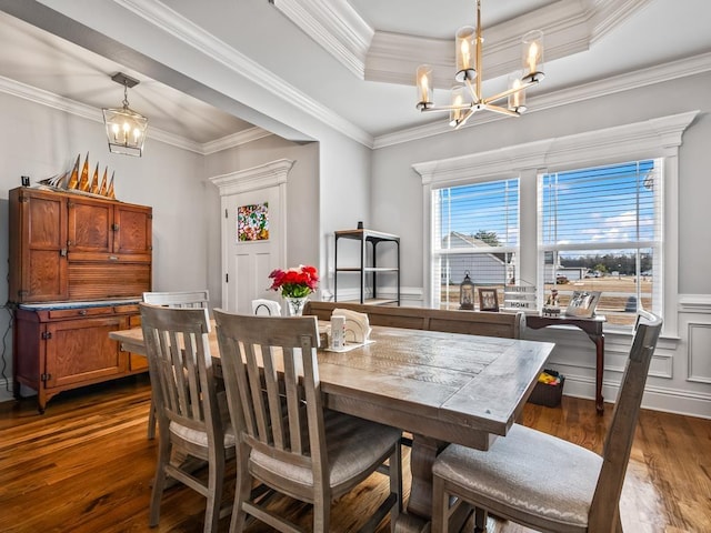 dining space with crown molding, dark wood-type flooring, and a chandelier