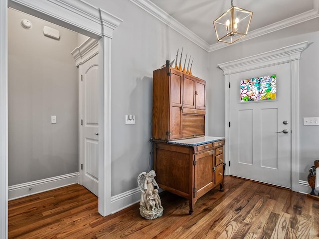 foyer featuring crown molding, dark hardwood / wood-style flooring, and a notable chandelier