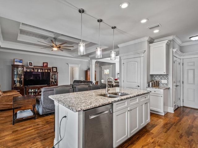 kitchen featuring dishwasher, an island with sink, sink, white cabinets, and light stone countertops