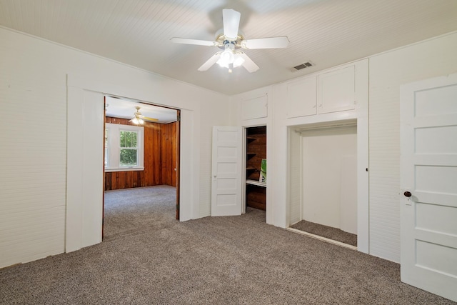 unfurnished bedroom featuring carpet flooring and a ceiling fan