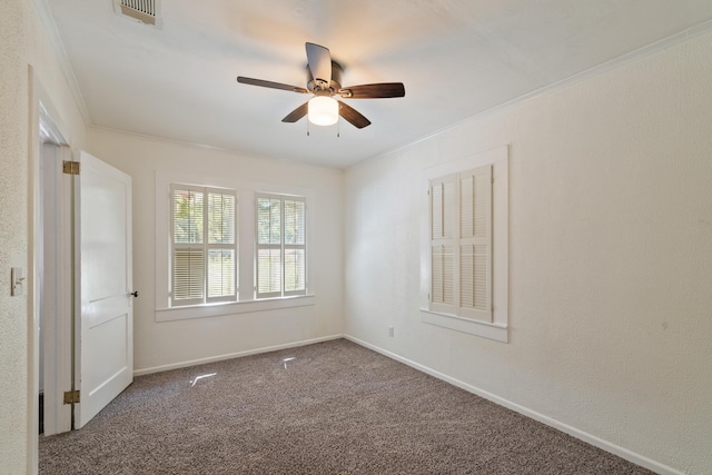 unfurnished room featuring a ceiling fan, carpet, crown molding, and baseboards