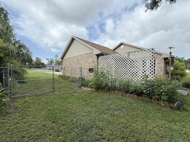 601 Judson Dr, Perry, FL 32348 - view of property exterior with brick siding and a gate