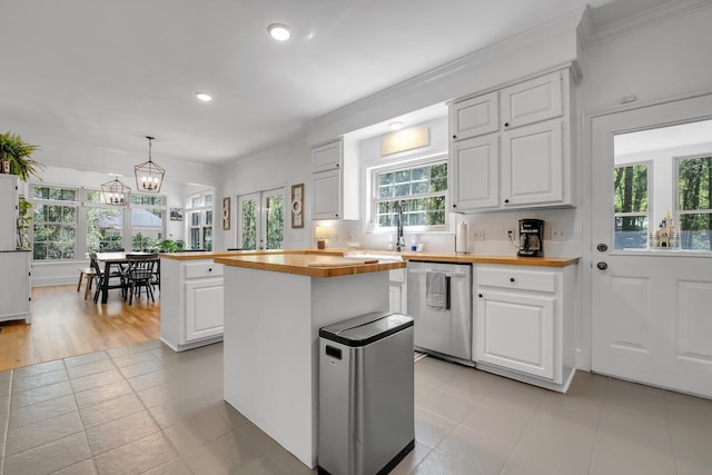 2227 Ten Oaks Dr, Tallahassee, FL 32312 - kitchen with backsplash, white cabinetry, dishwasher, a center island, and butcher block counters
