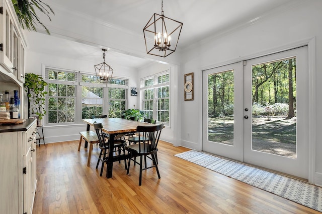 2227 Ten Oaks Dr, Tallahassee, FL 32312 - dining area featuring a notable chandelier, crown molding, french doors, baseboards, and light wood-style floors