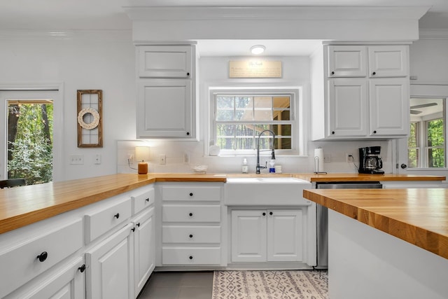 2227 Ten Oaks Dr, Tallahassee, FL 32312 - kitchen featuring butcher block counters, decorative backsplash, a sink, and white cabinets
