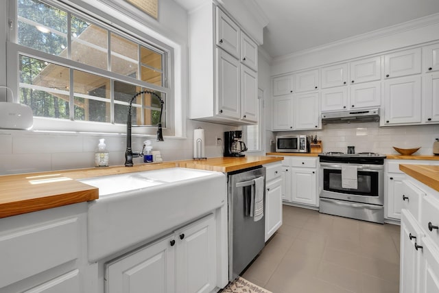 2227 Ten Oaks Dr, Tallahassee, FL 32312 - kitchen with decorative backsplash, white cabinets, wood counters, stainless steel appliances, and under cabinet range hood