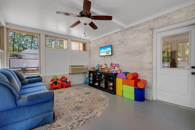 2227 Ten Oaks Dr, Tallahassee, FL 32312 - playroom with an AC wall unit, tile patterned floors, beam ceiling, brick wall, and a ceiling fan