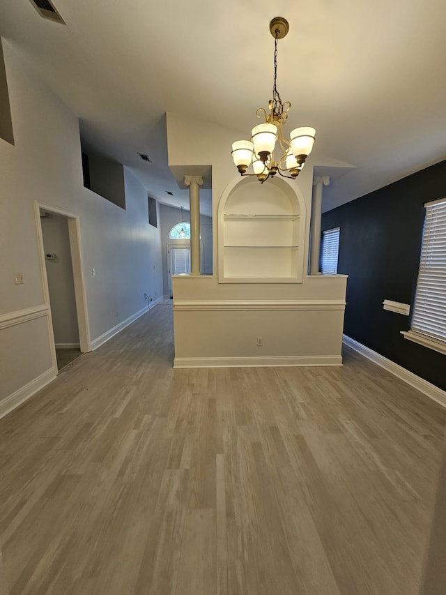 2943 Tewkesbury Trce, Tallahassee, FL 32309 - unfurnished dining area featuring a chandelier, wood finished floors, and baseboards