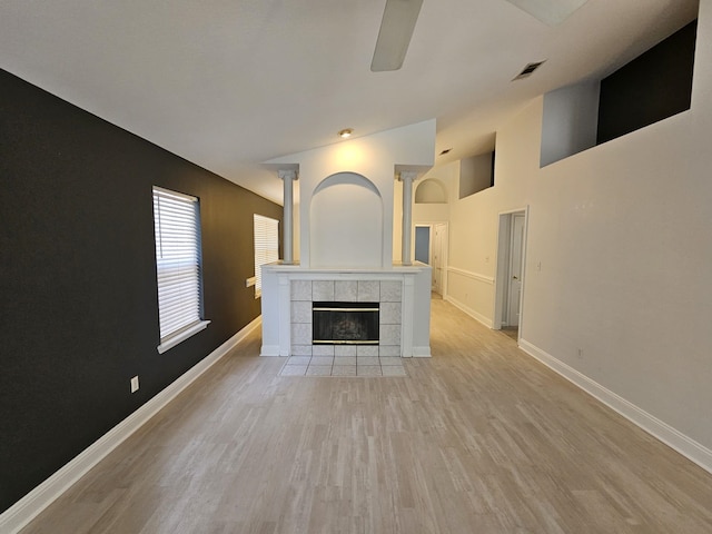 2943 Tewkesbury Trce, Tallahassee, FL 32309 - unfurnished living room featuring a tile fireplace, baseboards, and light wood finished floors
