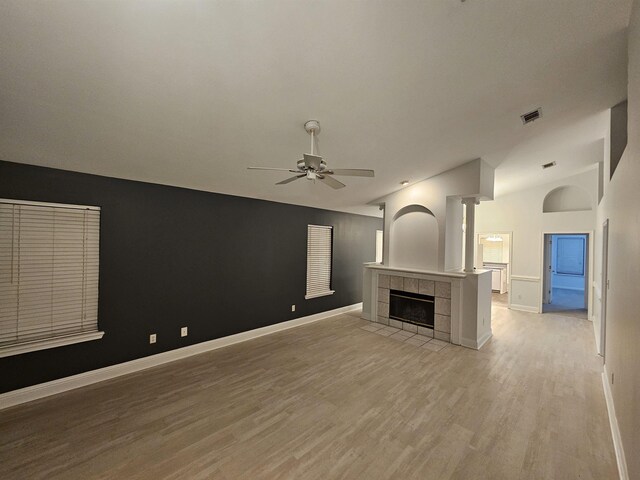 2943 Tewkesbury Trce, Tallahassee, FL 32309 - unfurnished living room featuring a ceiling fan, a fireplace, light wood-style floors, baseboards, and vaulted ceiling