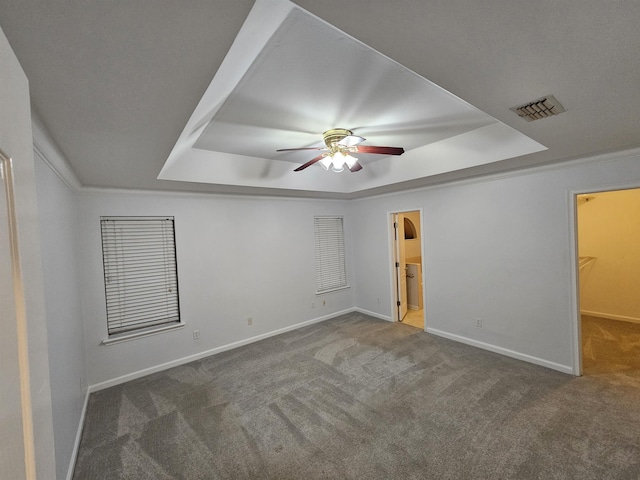 2943 Tewkesbury Trce, Tallahassee, FL 32309 - unfurnished bedroom with a tray ceiling, carpet flooring, baseboards, a spacious closet, and a ceiling fan