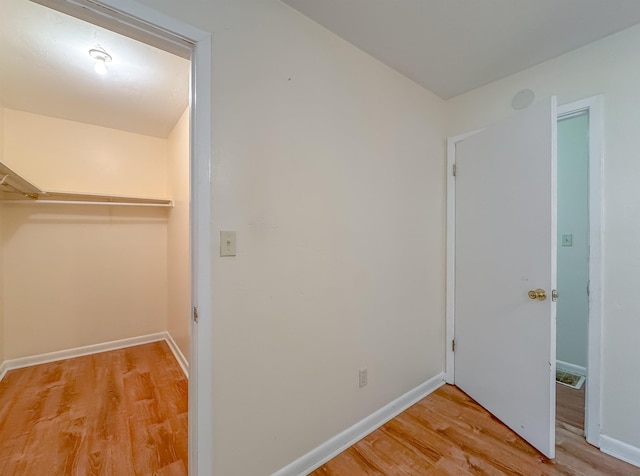 interior space with baseboards and wood finished floors