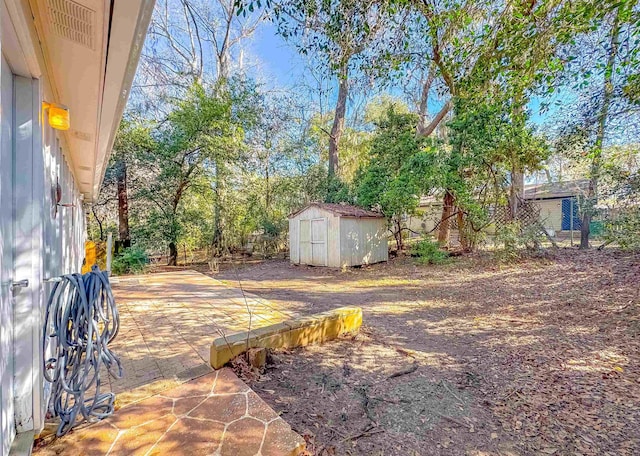 view of patio featuring fence, an outdoor structure, and a storage unit