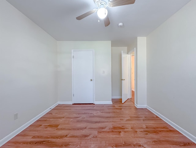 unfurnished bedroom with baseboards, light wood-type flooring, and ceiling fan