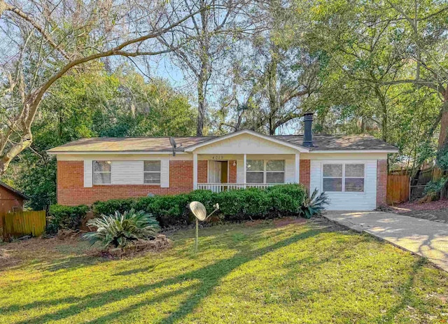 ranch-style house featuring fence, a front lawn, and brick siding