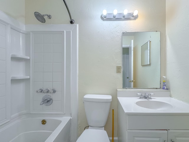 bathroom featuring vanity, tub / shower combination, toilet, and a textured wall