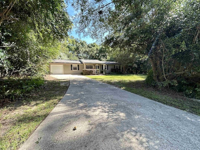 6842 Tomy Lee Trl, Tallahassee, FL 32309 - single story home with concrete driveway, a front lawn, and a garage