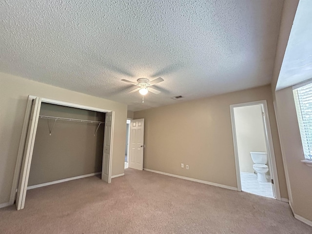 6842 Tomy Lee Trl, Tallahassee, FL 32309 - unfurnished bedroom featuring a closet, a textured ceiling, light carpet, baseboards, and ceiling fan