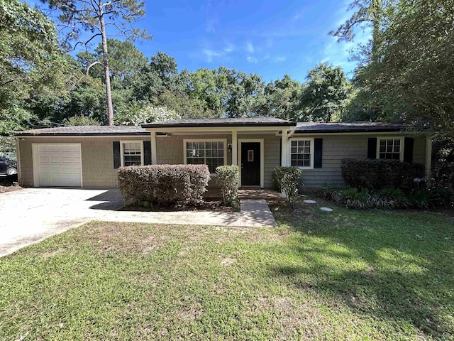 6842 Tomy Lee Trl, Tallahassee, FL 32309 - ranch-style house featuring an attached garage, a front lawn, driveway, and view of wooded area