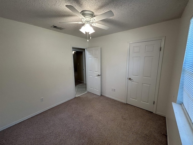 6842 Tomy Lee Trl, Tallahassee, FL 32309 - unfurnished bedroom featuring carpet flooring, baseboards, a textured ceiling, and ceiling fan