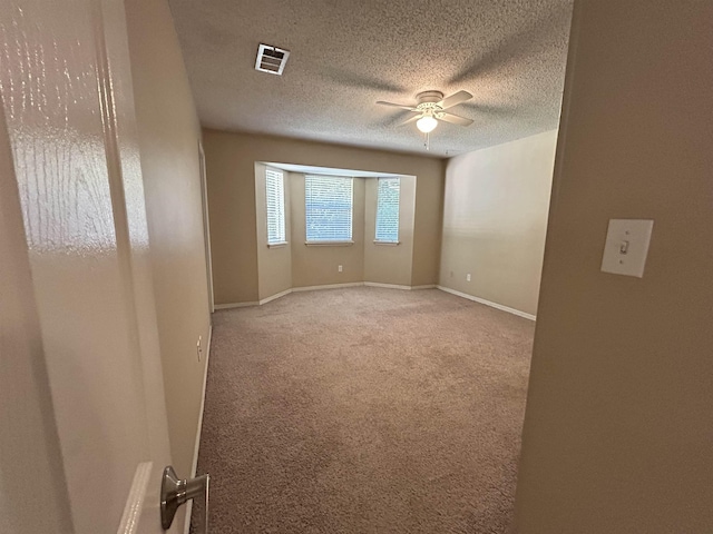 6842 Tomy Lee Trl, Tallahassee, FL 32309 - empty room featuring ceiling fan, light colored carpet, a textured ceiling, and baseboards