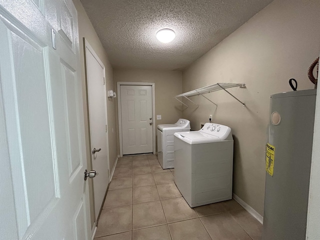 6842 Tomy Lee Trl, Tallahassee, FL 32309 - laundry area with electric water heater, separate washer and dryer, a textured ceiling, light tile patterned floors, and baseboards