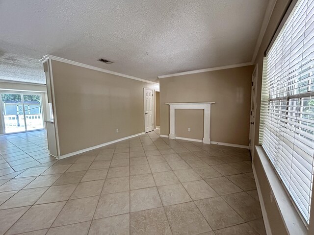 6842 Tomy Lee Trl, Tallahassee, FL 32309 - spare room with a textured ceiling, light tile patterned floors, baseboards, and ornamental molding
